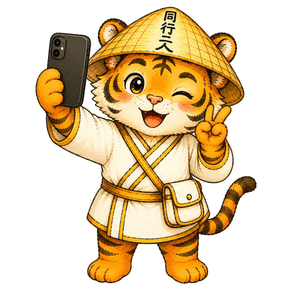 スマートフォンを持ち、ウインクしながらピースサインで自撮りするお遍路虎のイラスト
