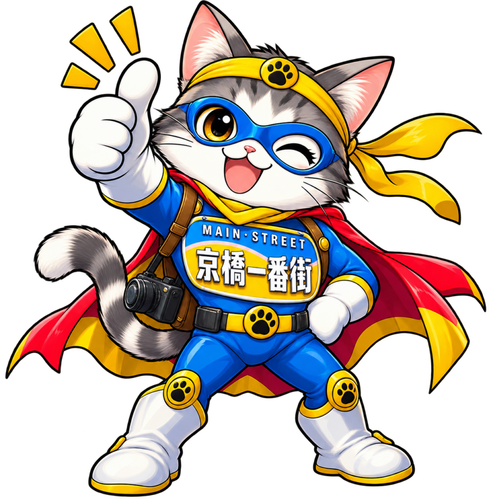 京橋一番街の衣装を着て、ウインクしながら親指を立てるヒーロー猫